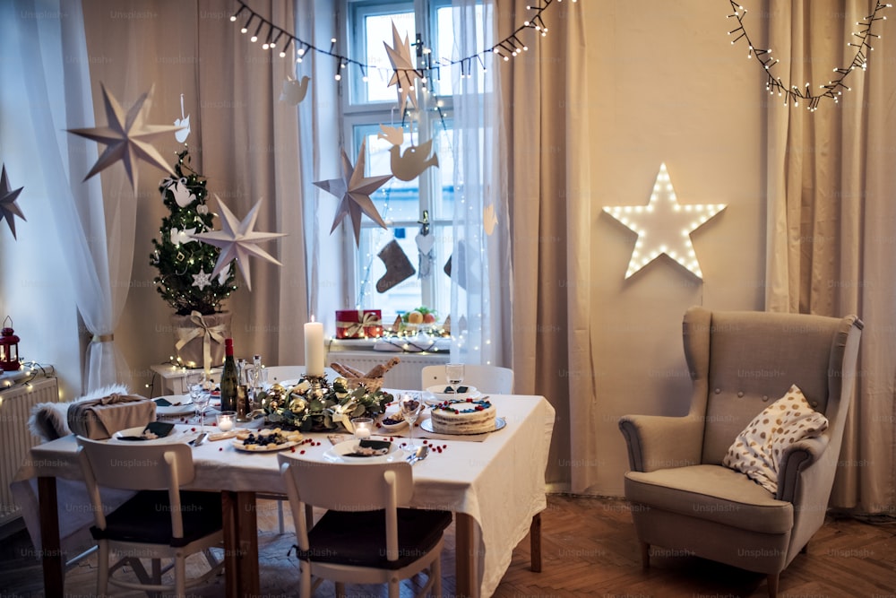 A decorated table set for dinner meal at Christmas time.