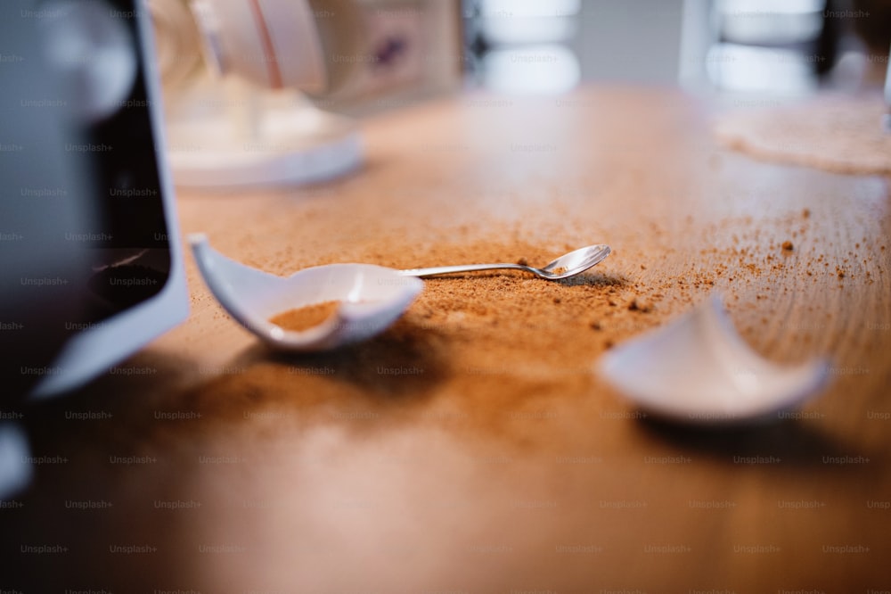 Close up of a mug broken into pieces on the kitchen table