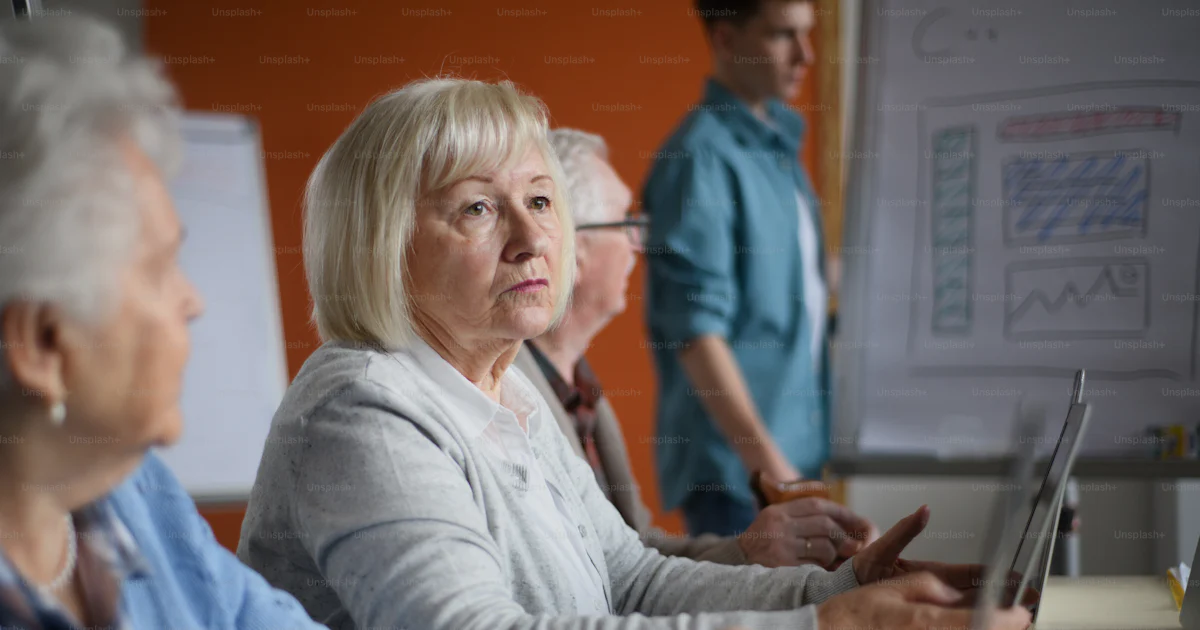 Learning Session Retirement A senior group in retirement home with young instructor learning ...