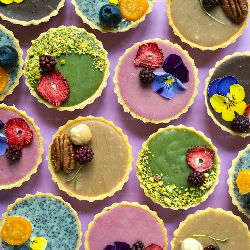 A top view of selection of colorful and delicious cake desserts on table.