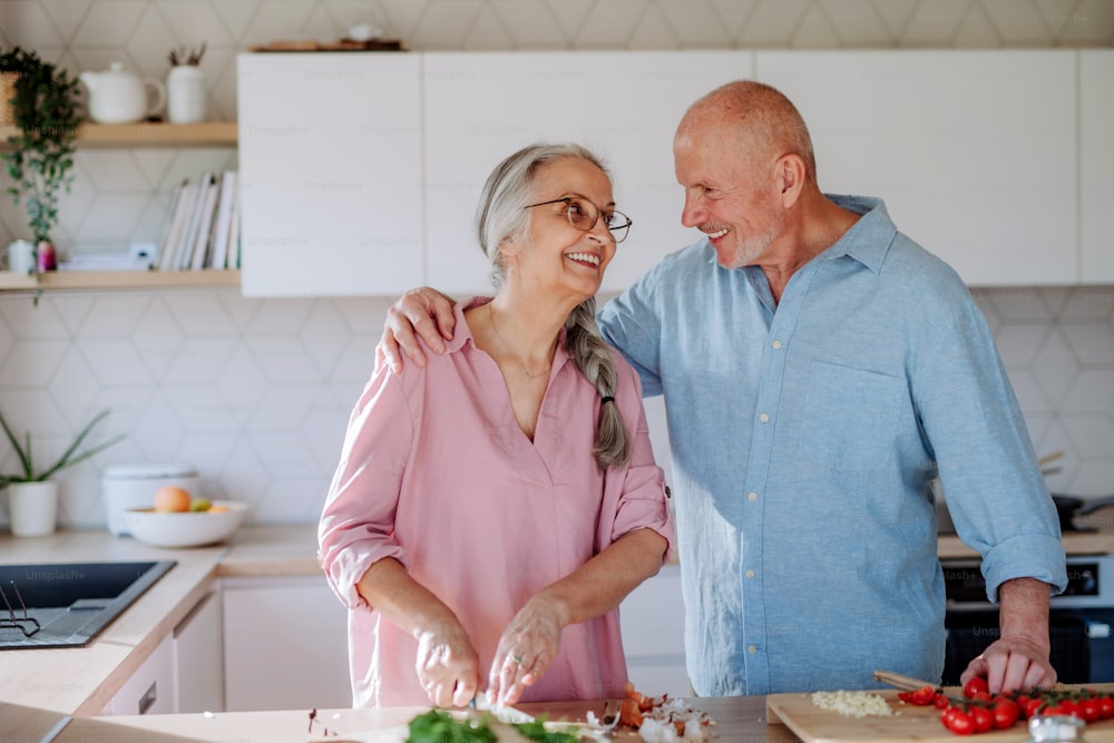 A senior couple cooking together at home.