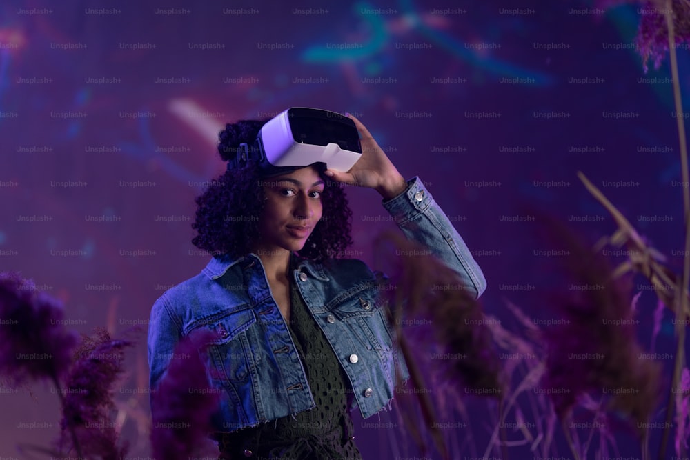 Metaverse digital cyber world technology, girl with virtual reality VR goggles playing augmented reality game, smiling, looking at camera,futuristic lifestyle