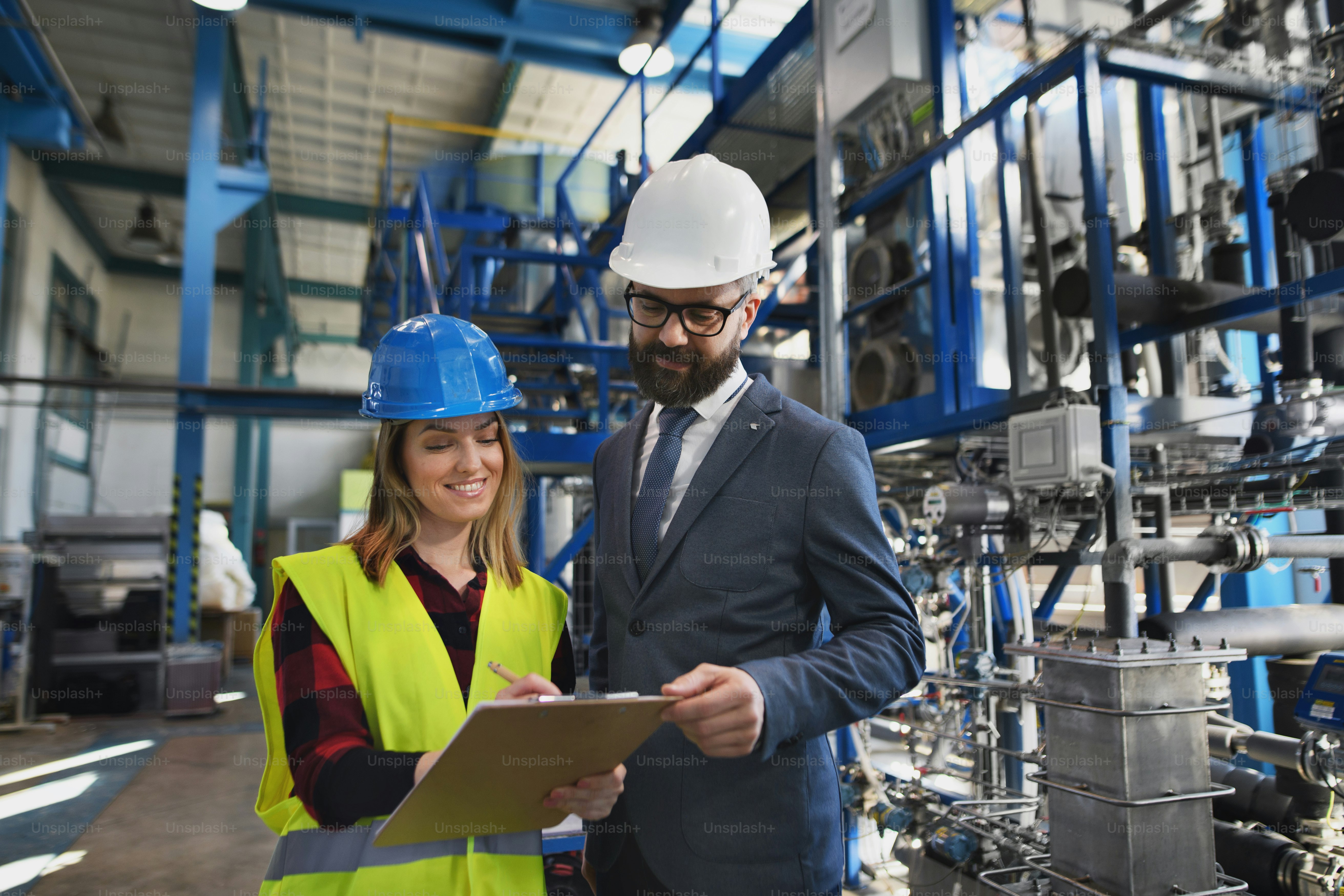 Female engineering manager and mechanic worker inside the factory photo ...