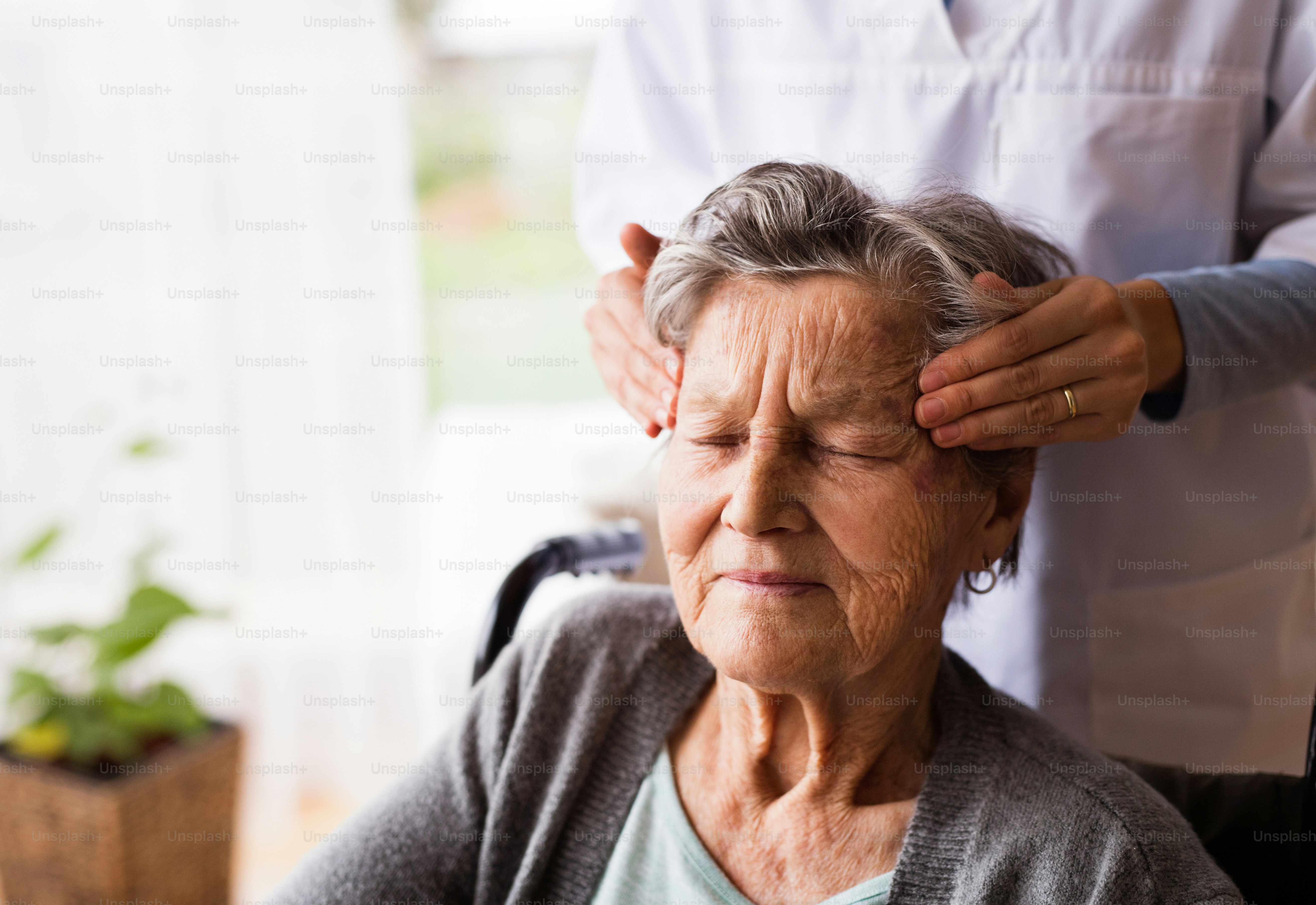 Health Visitor And A Senior Woman During Home Visit Unrecognizable 