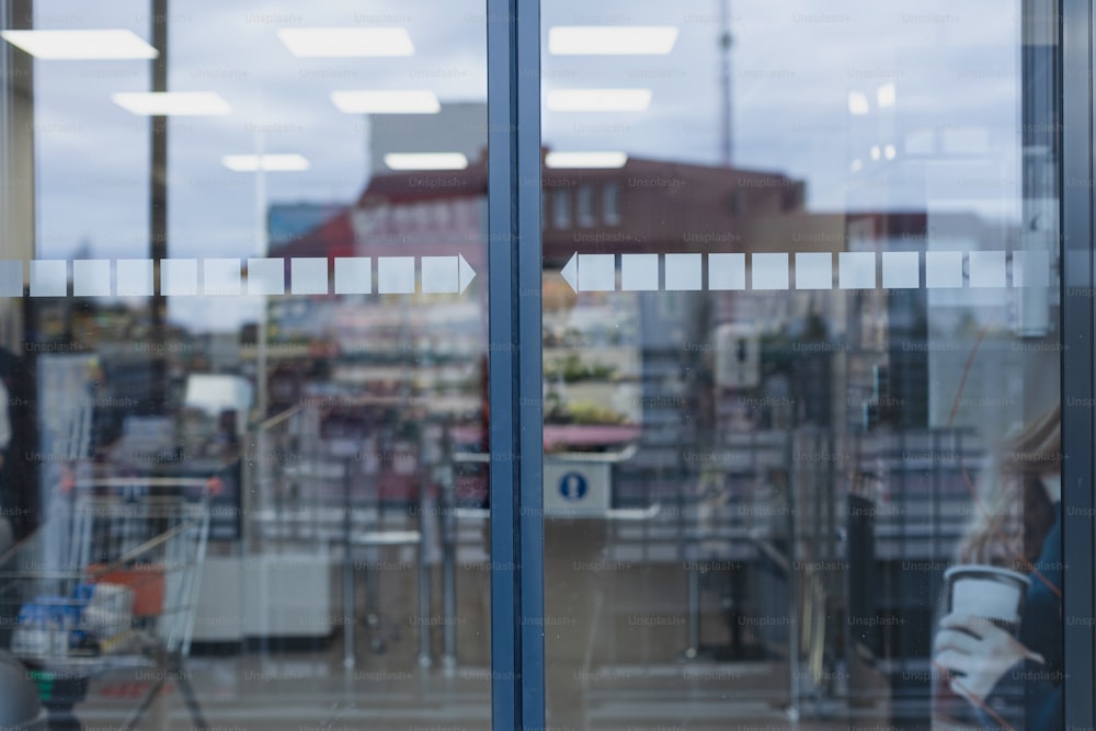 Closed glass of supermarket automatic door, front view.