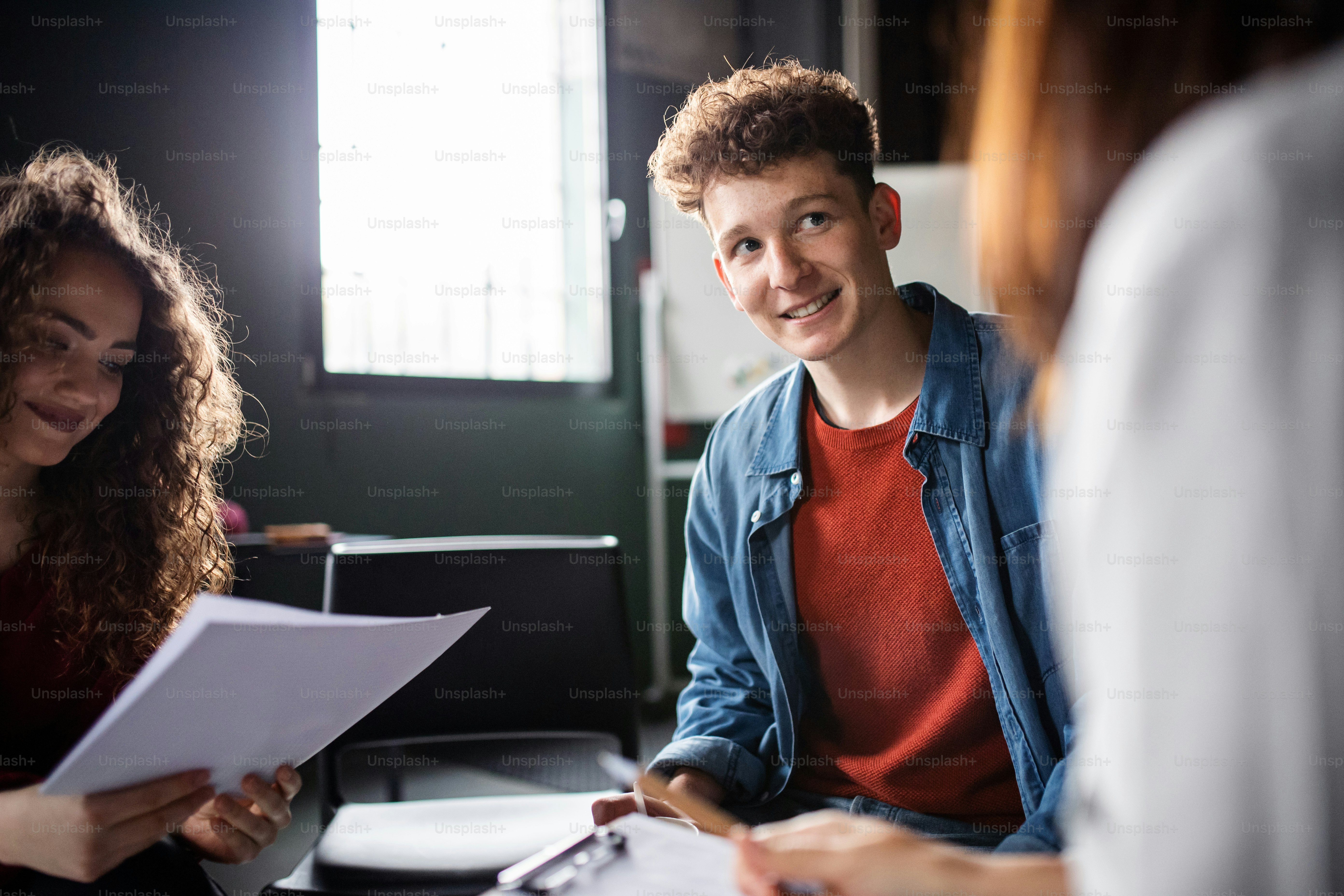 Men and women sitting in a circle during group therapy, talking.