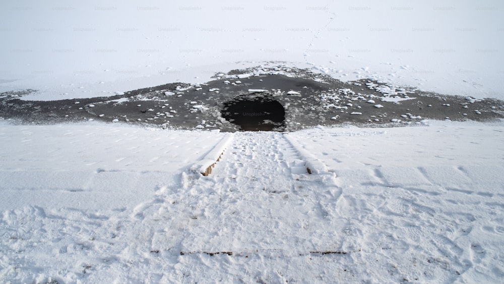 High angle view of a water hole in frozen lake.