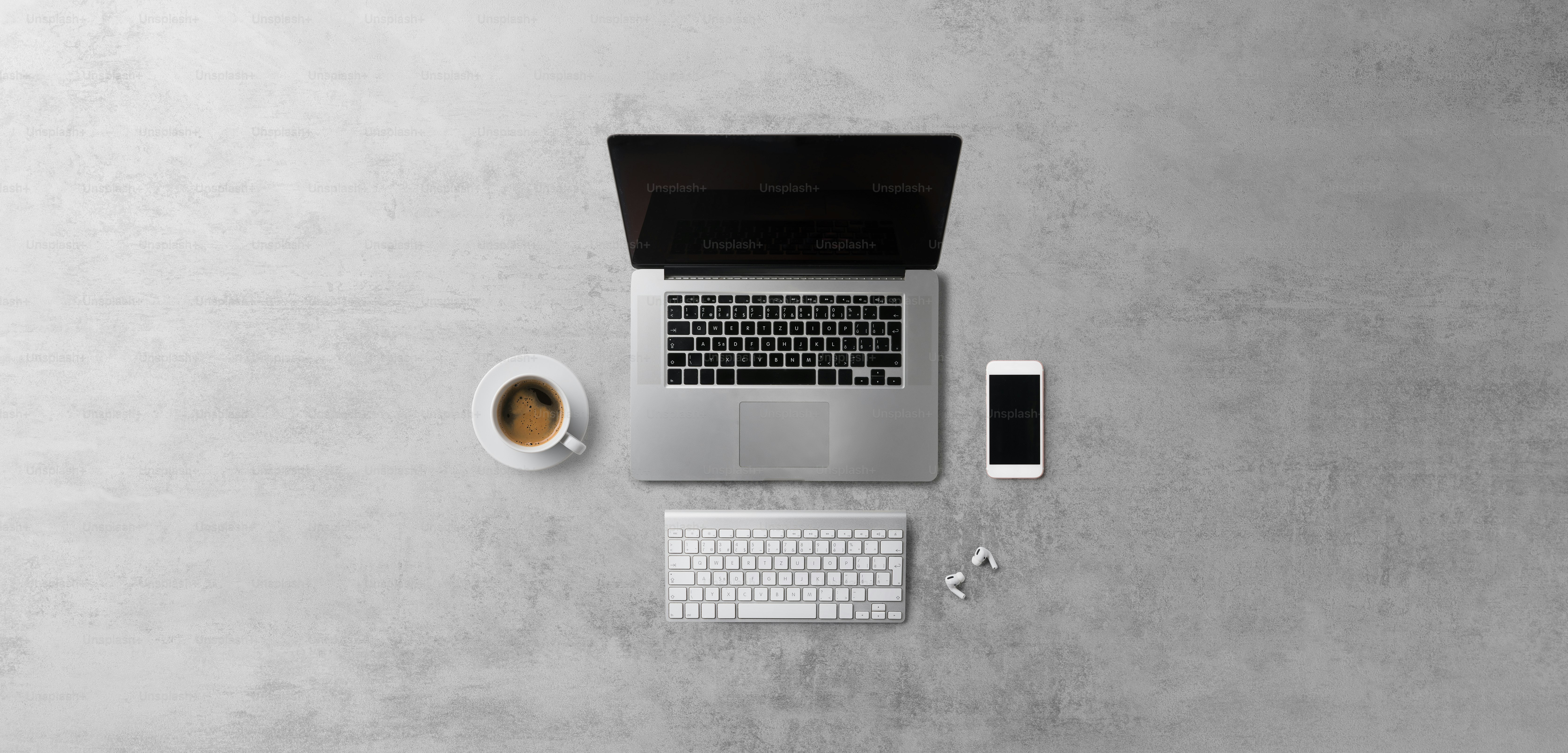 Flat lay top view office desk working space with laptop, and smartphone on gray background. Copy space.