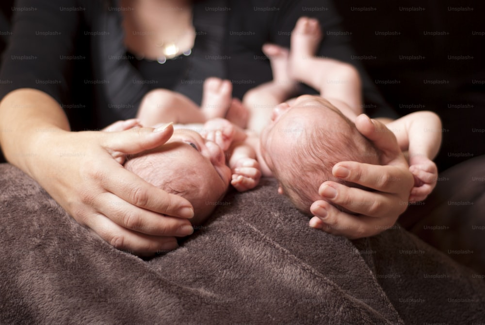 Little newborn twins are sleeping.