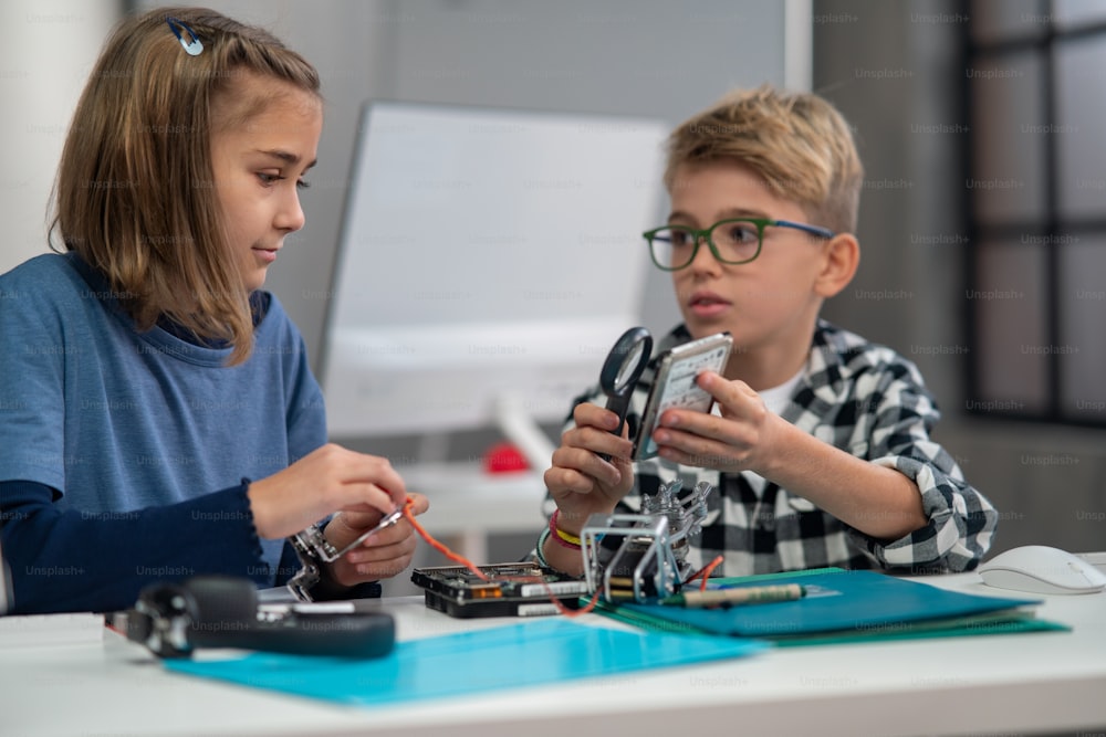 Pupils at school working with electronics component at a robotics classroom.