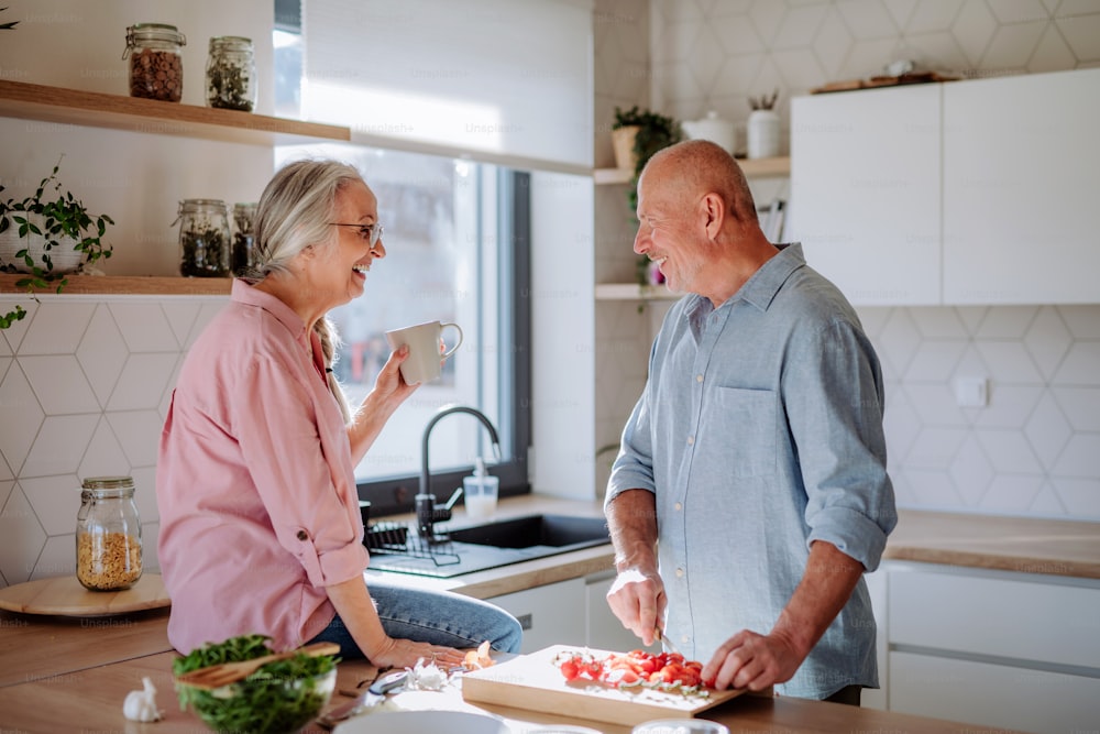 A senior couple cooking together at home.