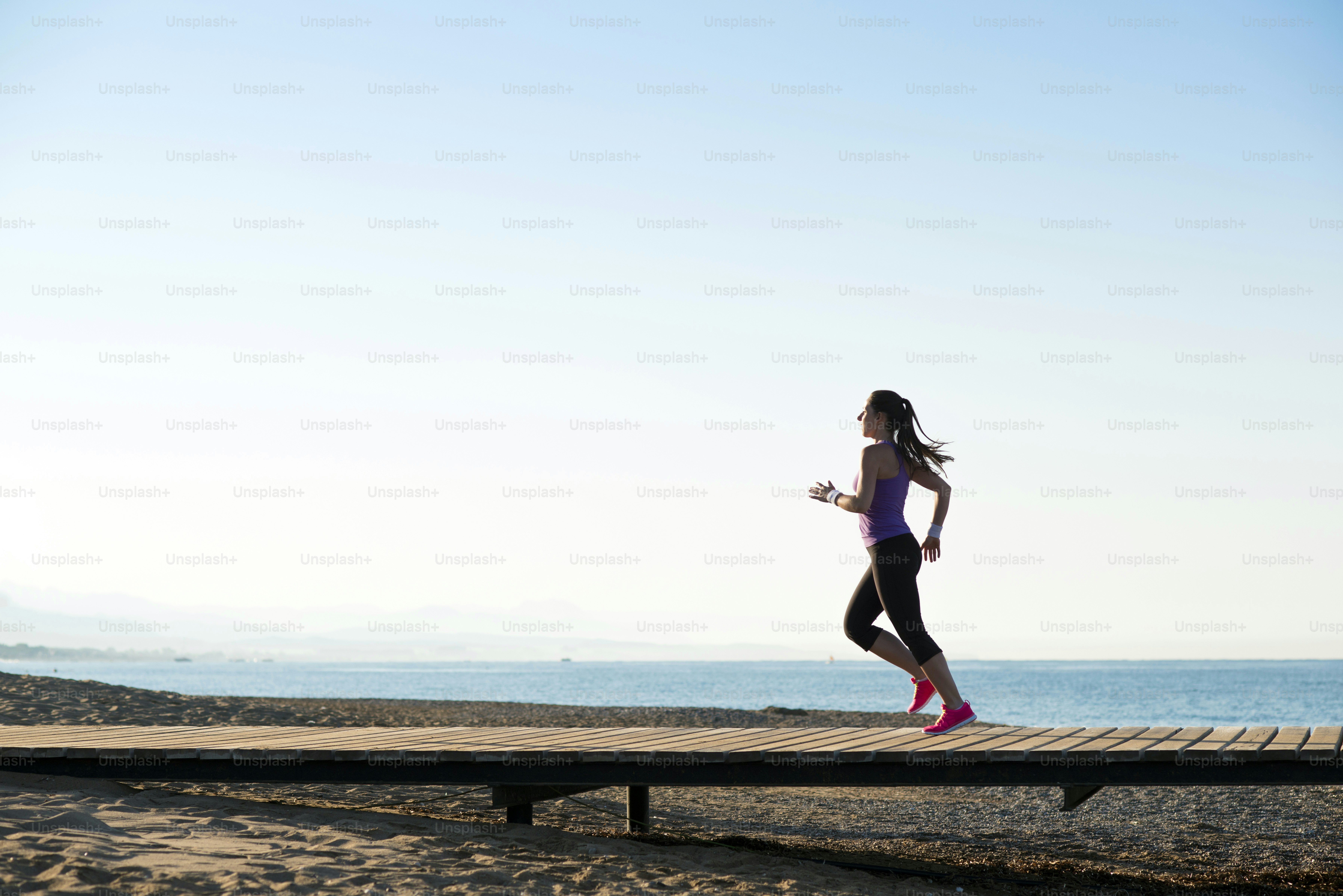 Young woman is running in sunny nature