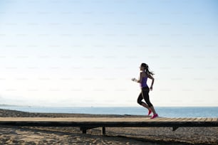 Young woman is running in sunny nature