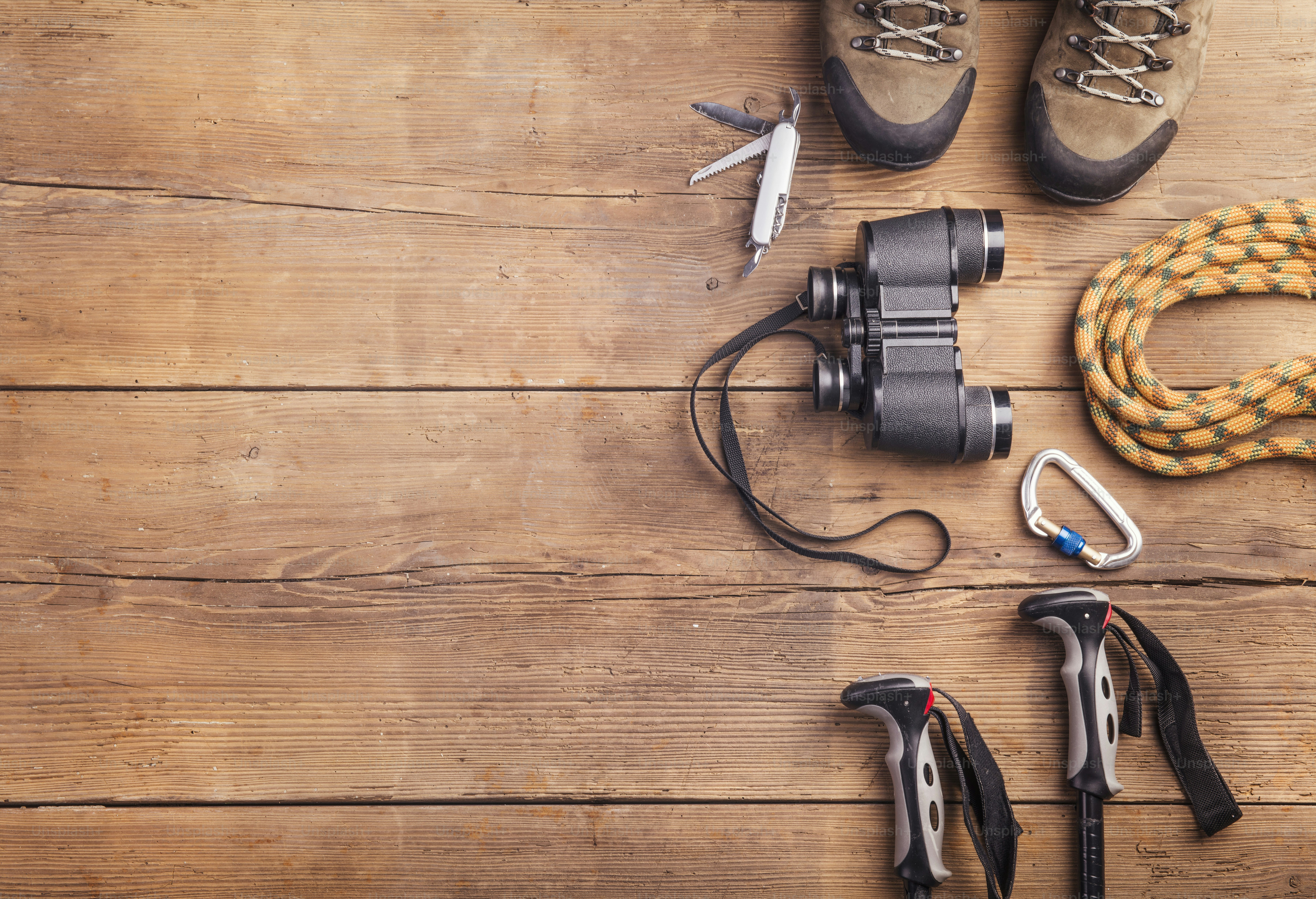 Equipment for hiking on a wooden floor background