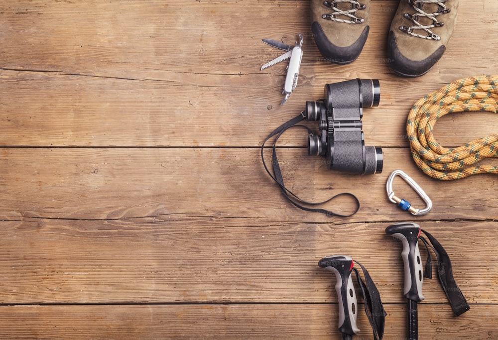 Equipment for hiking on a wooden floor background