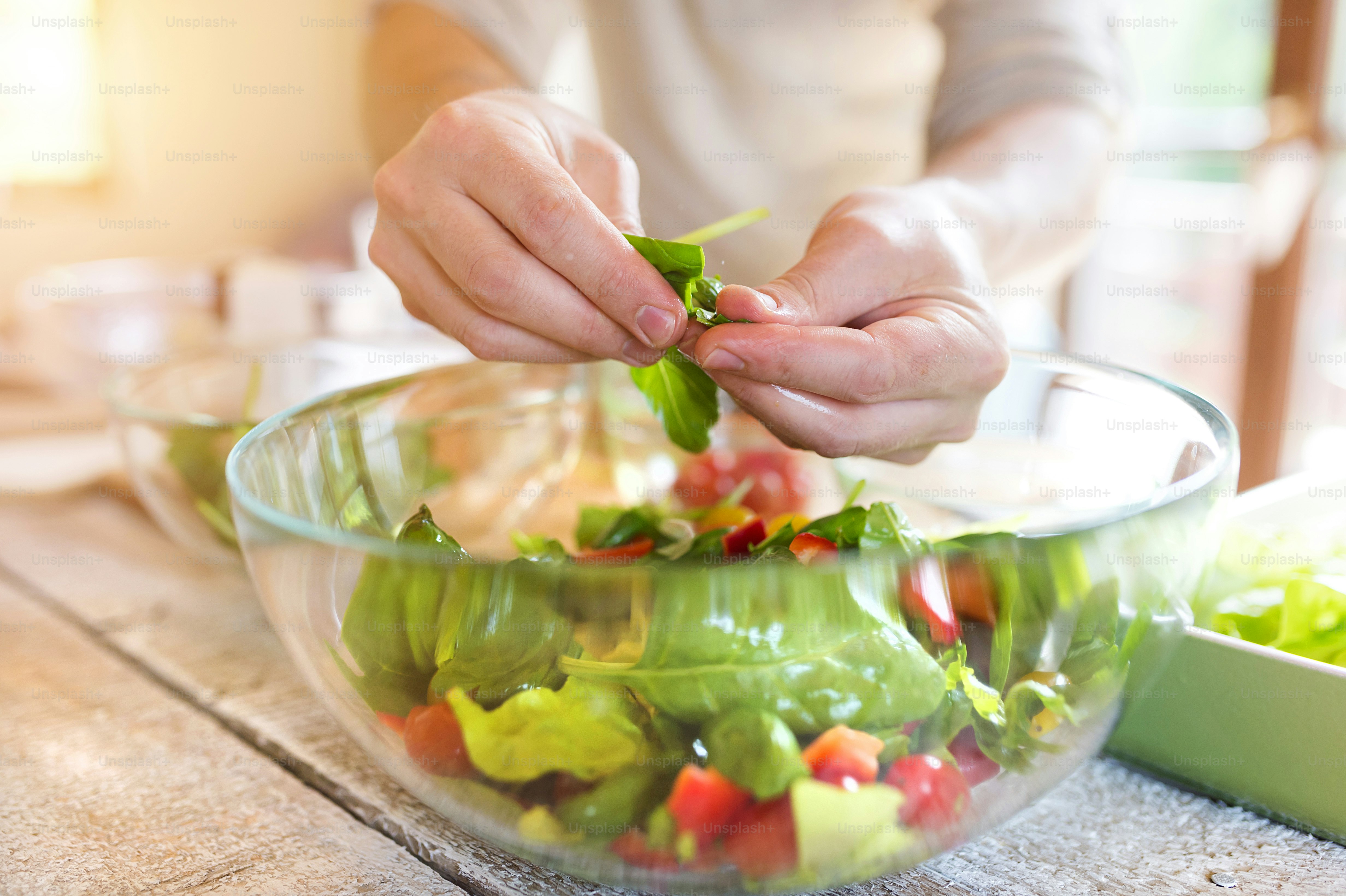 Unrecognizable man preparing ingredients for vegetable salad