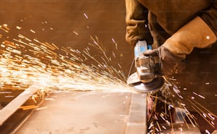 Close up of unrecognizable young man welding in a factory