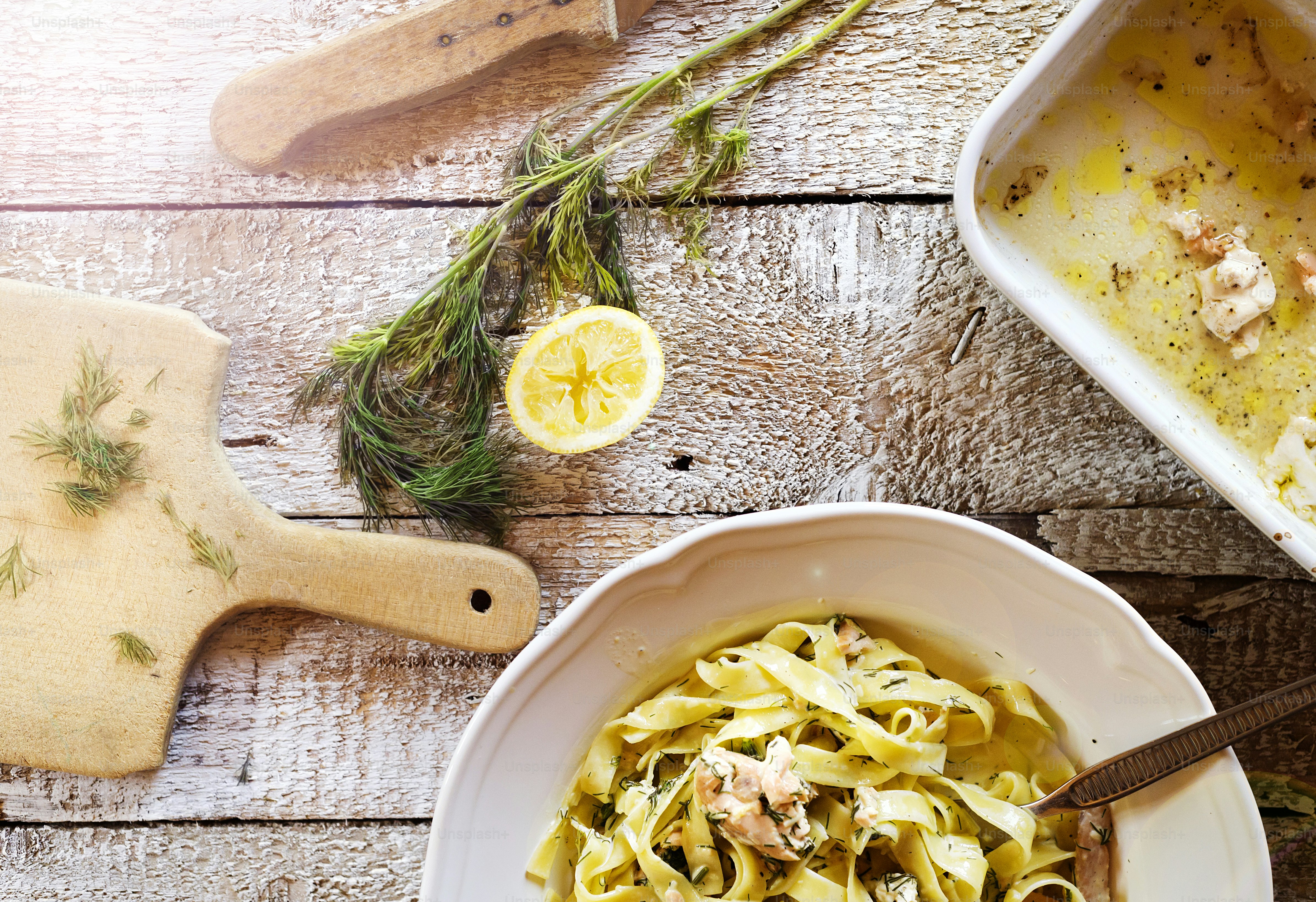 Salmon tagliatelle on a plate on wooden kitchen table