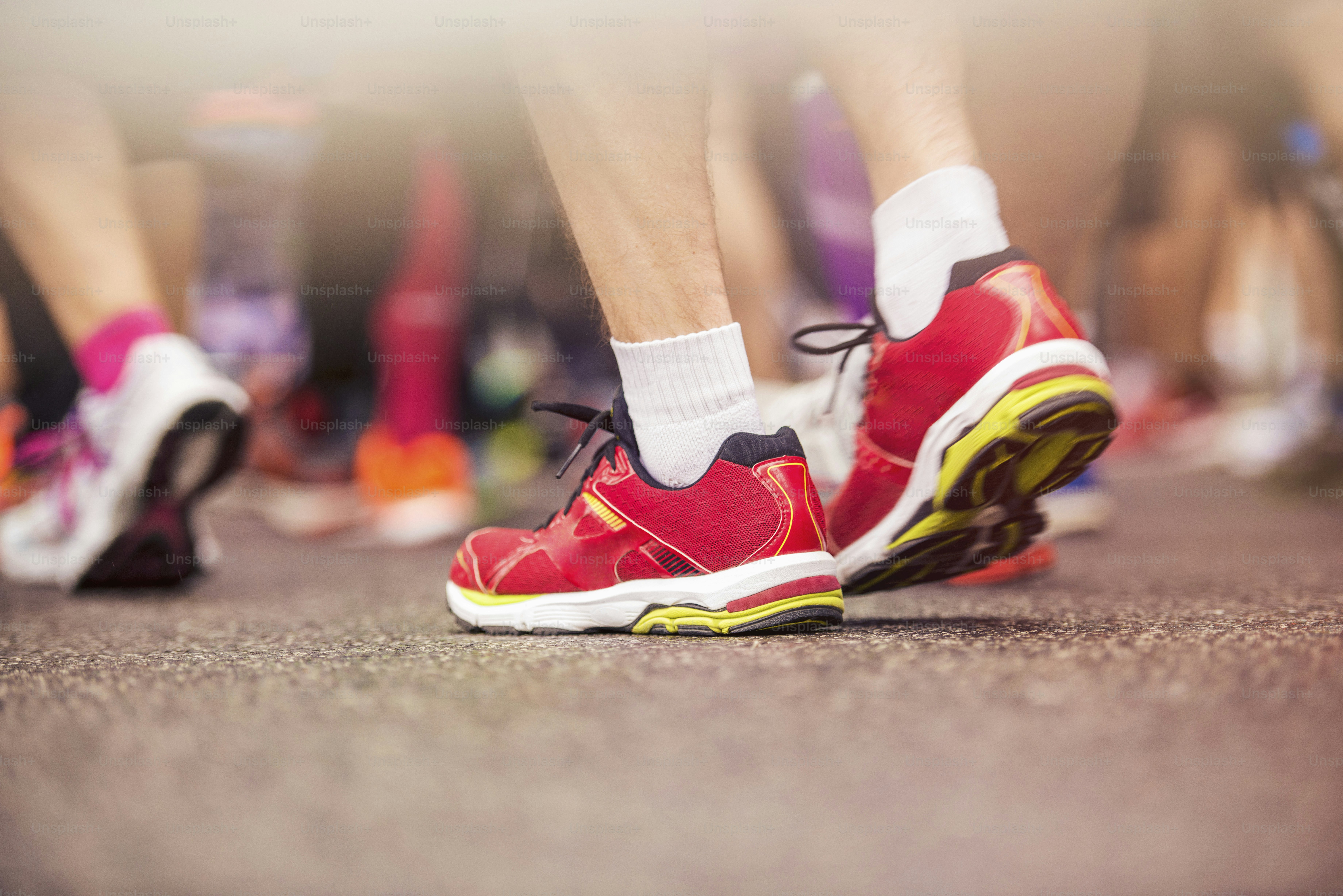 Detail of the legs of runners at the start of a marathon race photo ...