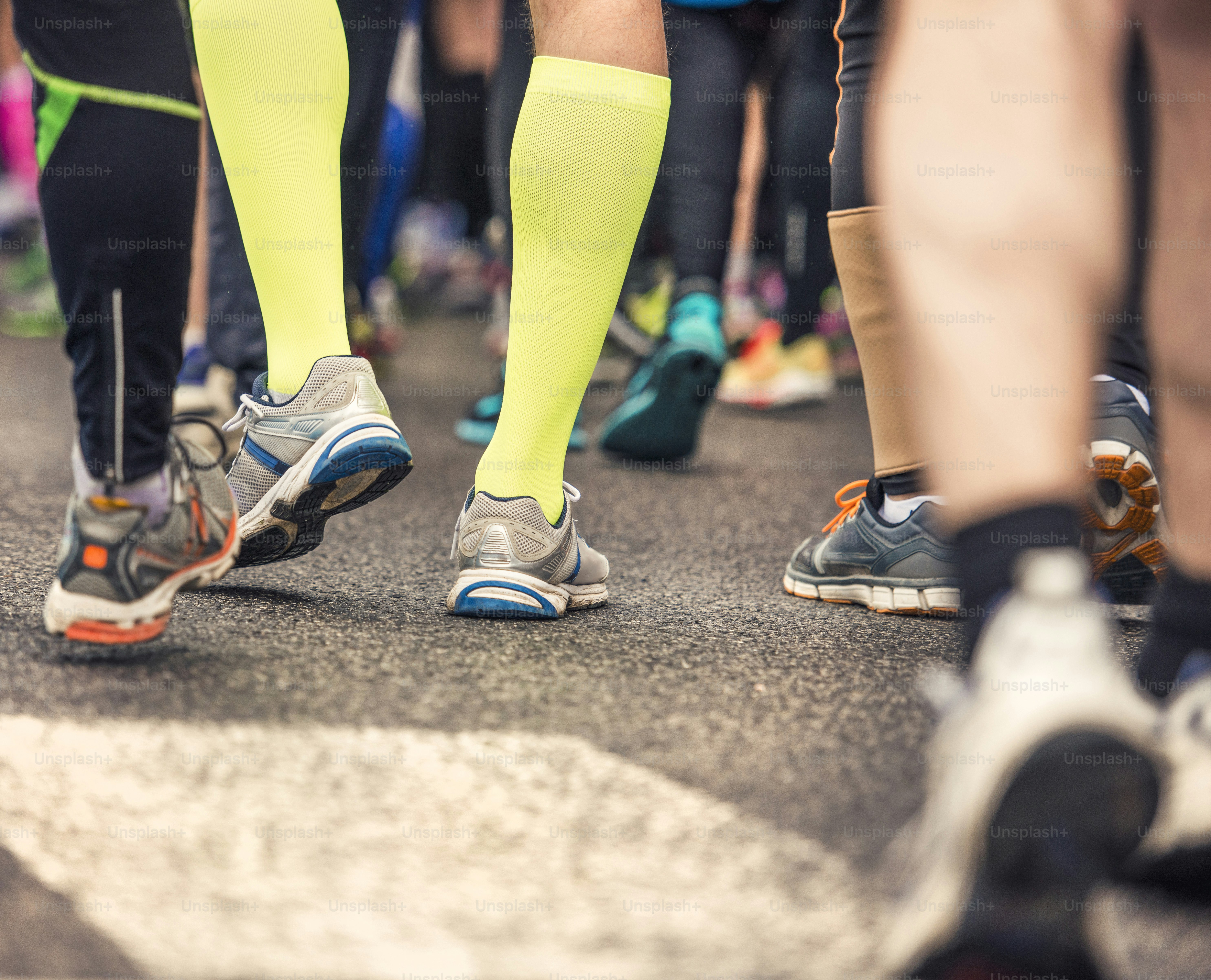 Detail of the legs of runners at the start of a marathon race photo ...