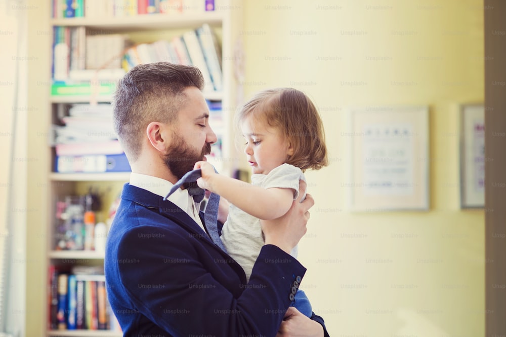 Young father hugging his daughter as he gets home from work