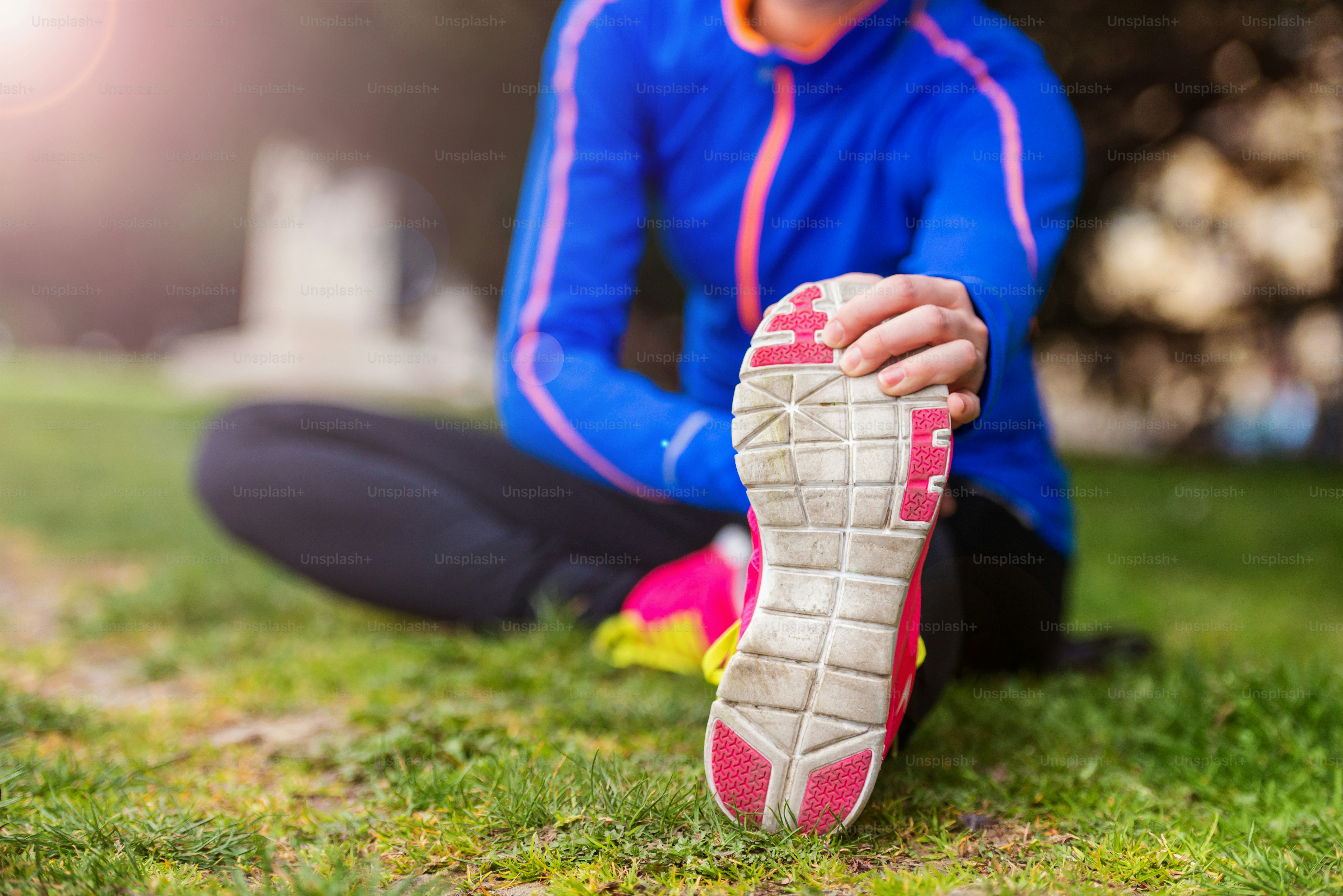 Young runner stretching before the city race