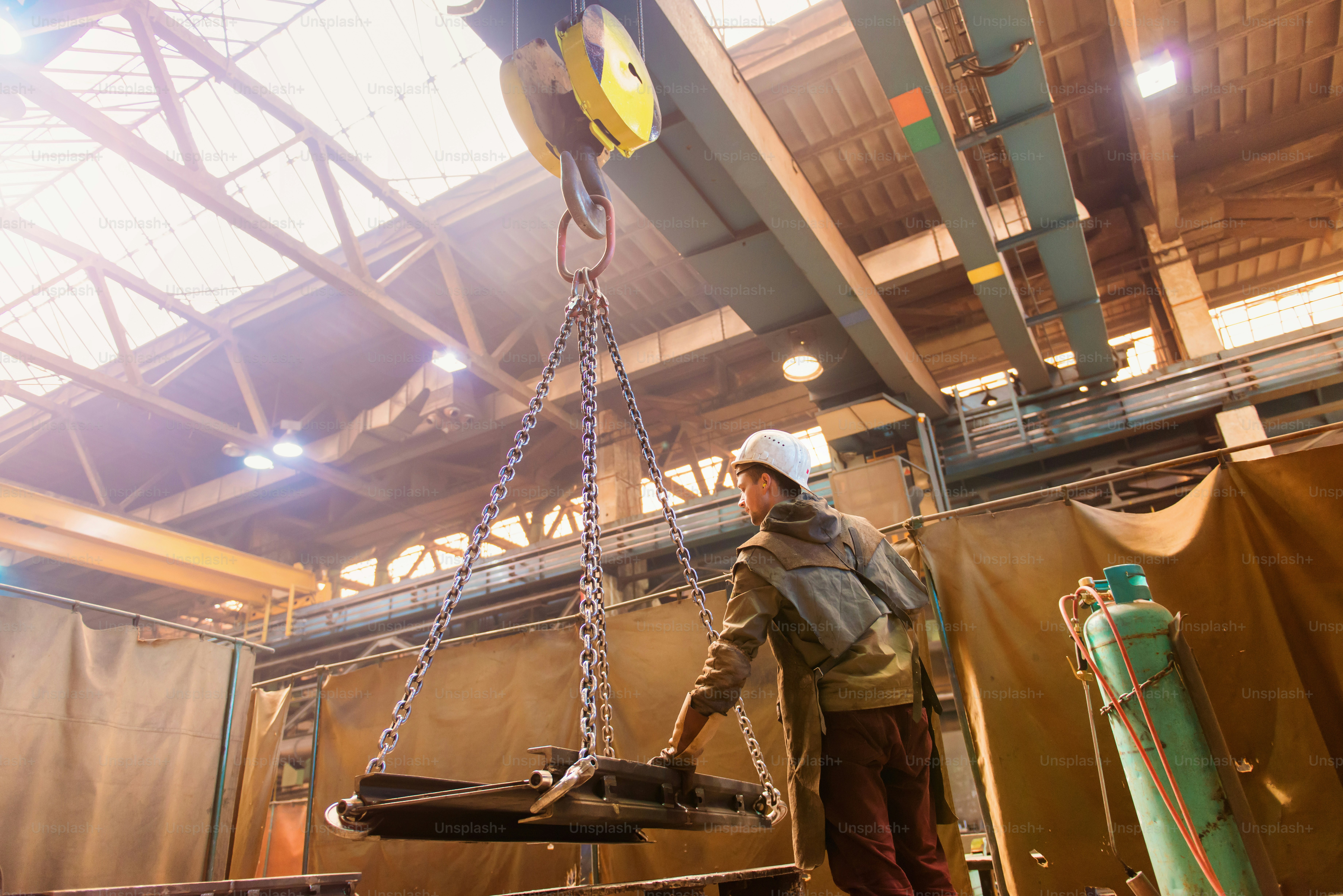 Young man in a factory preparing equipment for welding