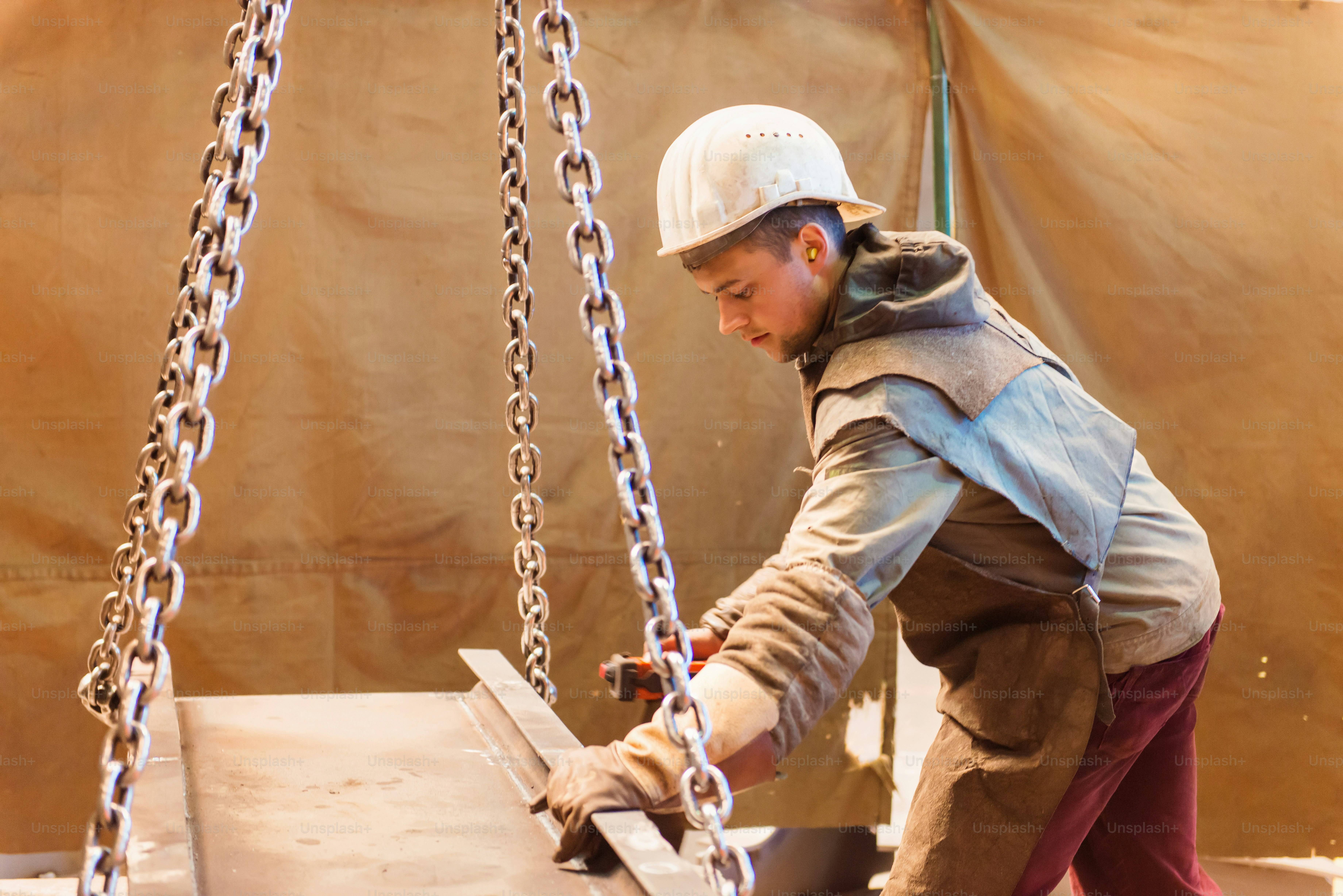 Young man in a factory preparing equipment for welding