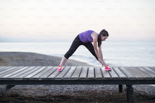 Young woman is running in sunny nature