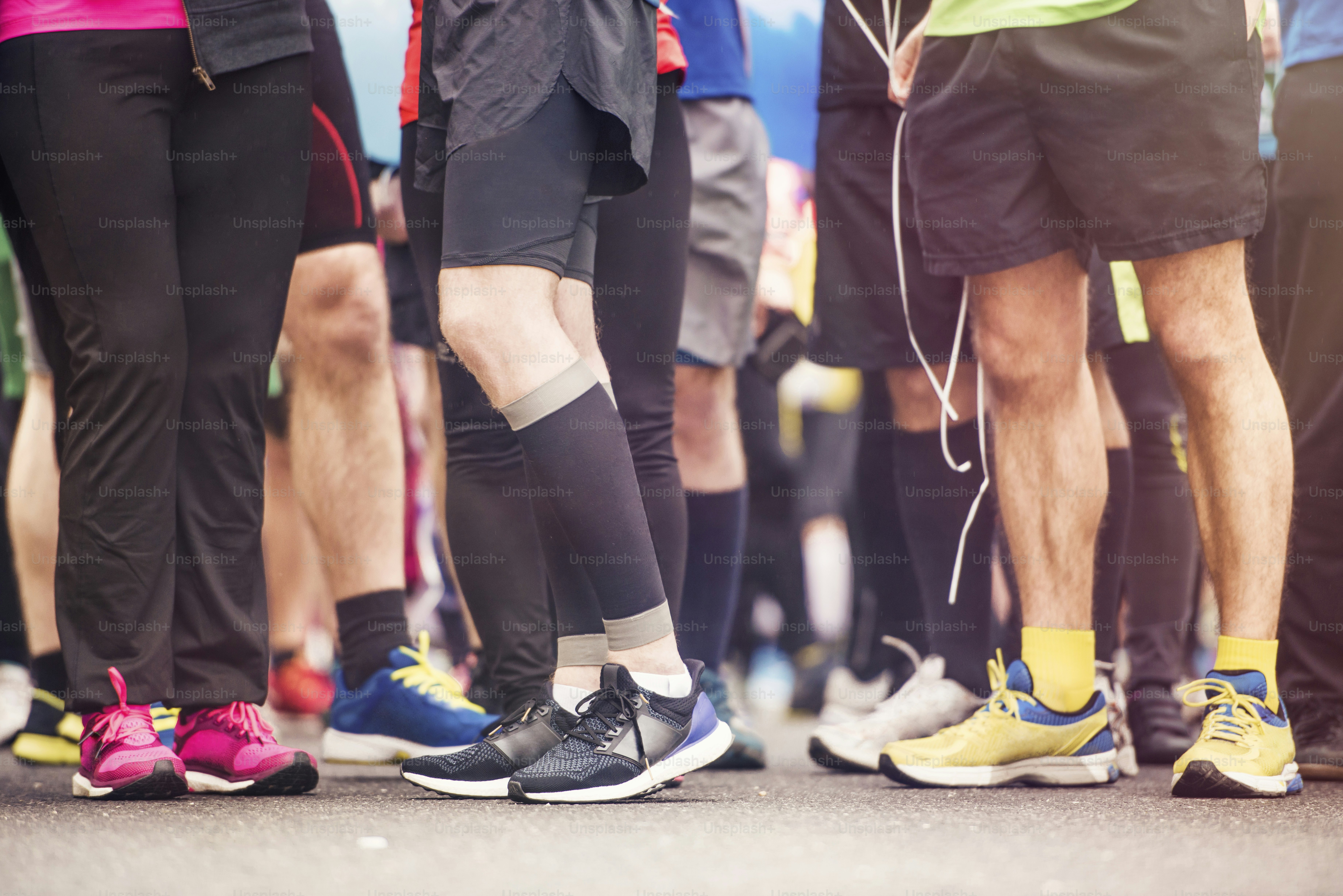 Detail of the legs of runners at the start of a marathon race photo ...