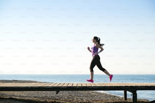 Young woman is running in sunny nature