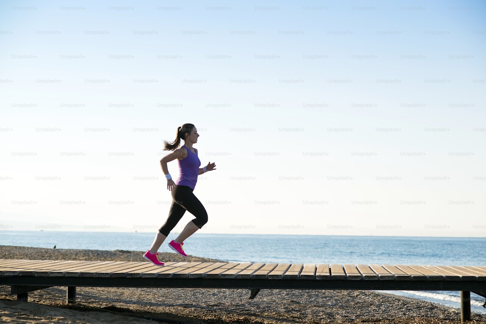 Young woman is running in sunny nature