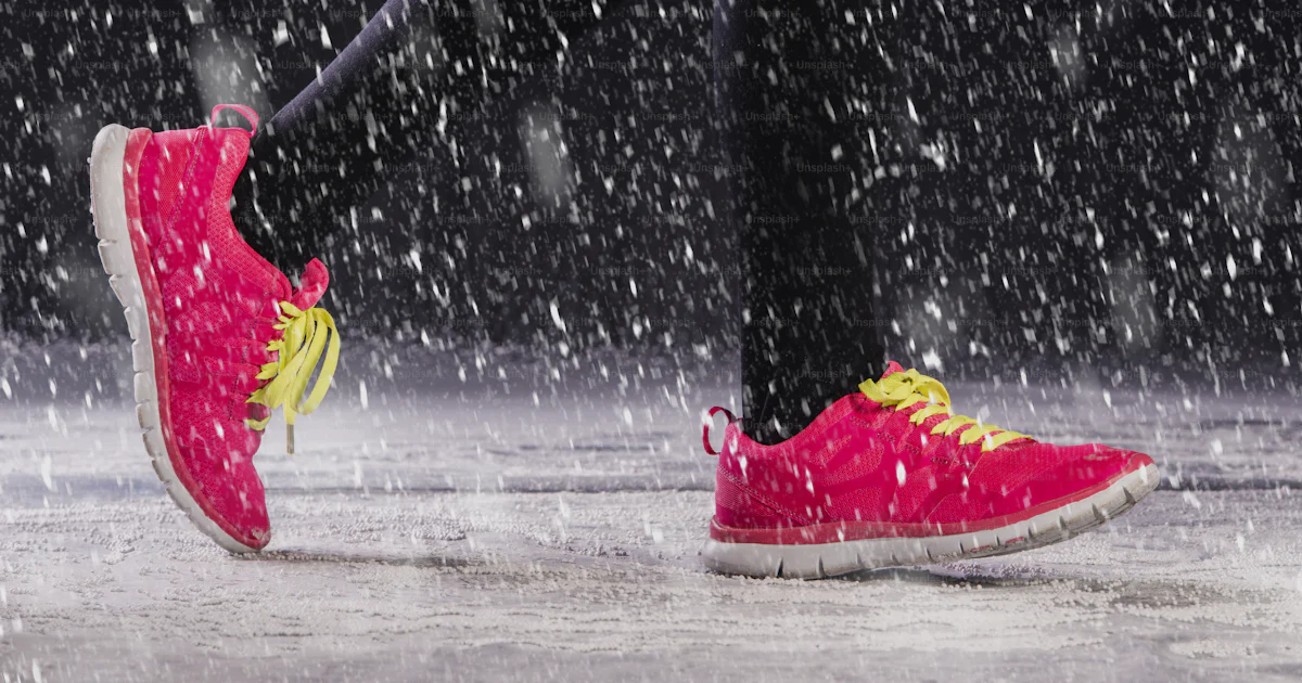 Snow Running Way Athlete woman is running during winter training outside in cold snow ...