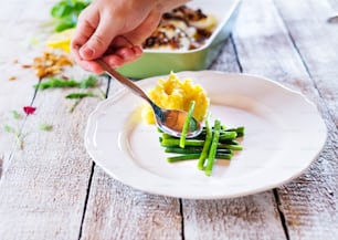 Man serving zander fish fillets on a plate