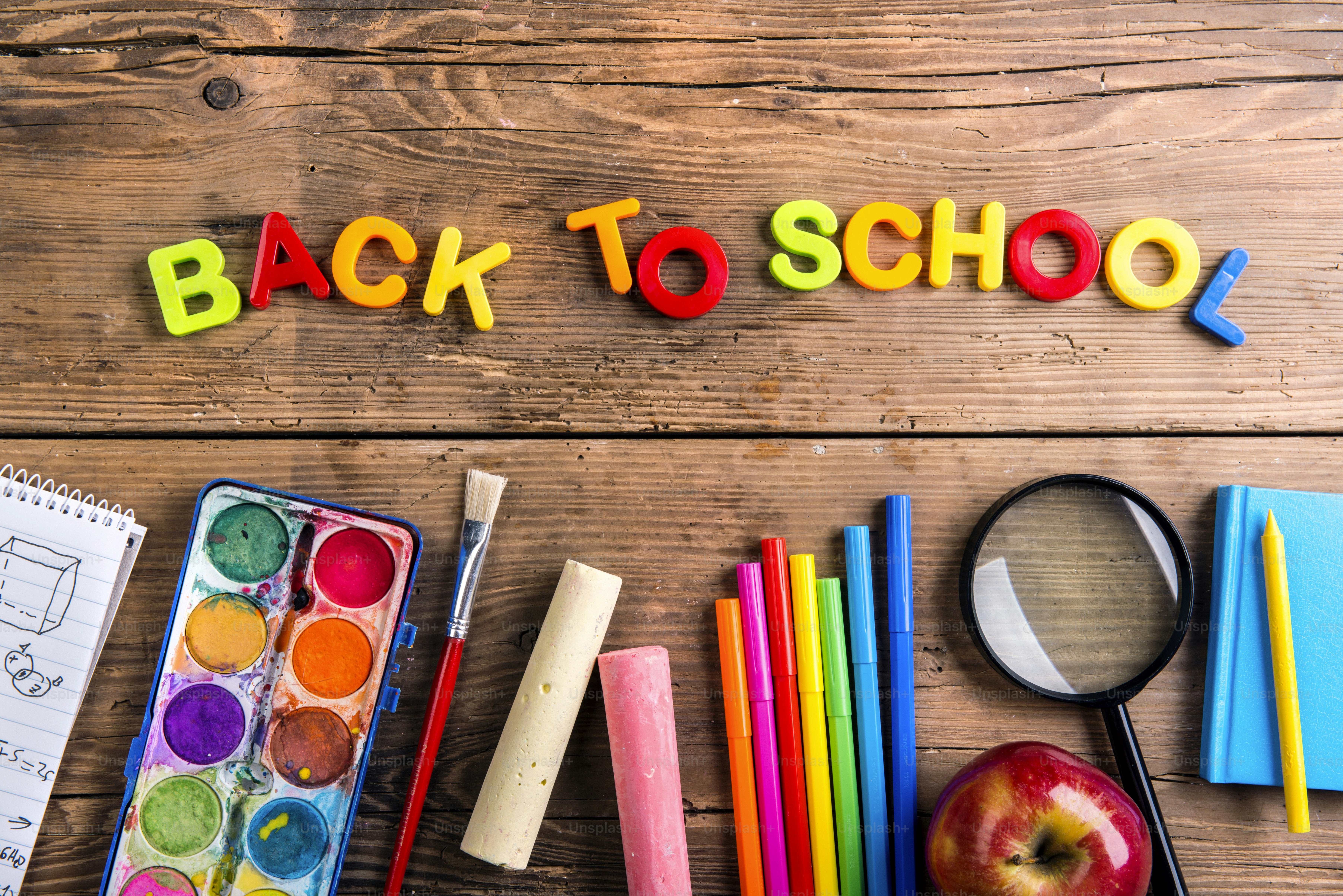 Desk with stationary. Studio shot on wooden background.