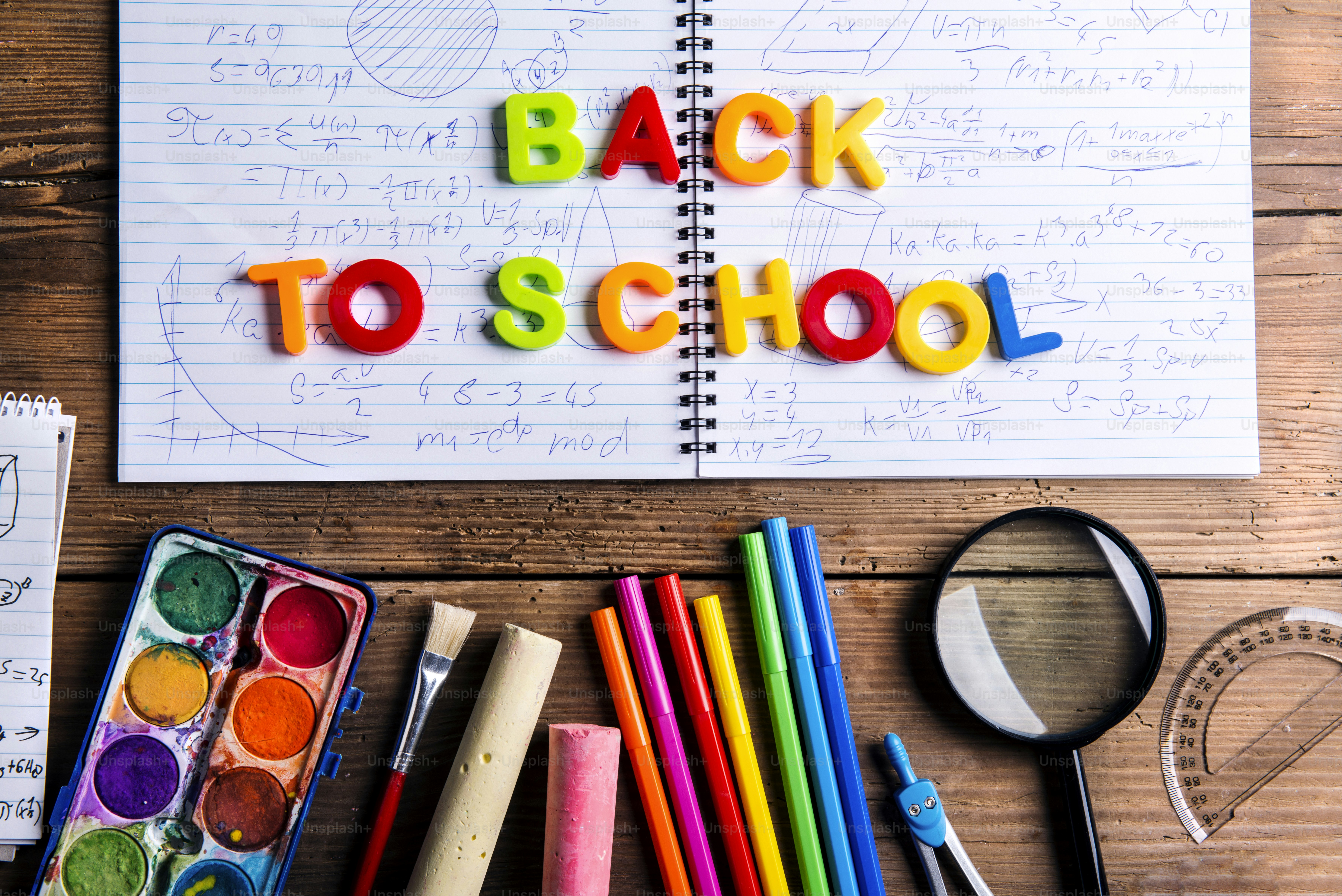 Desk with stationary. Studio shot on wooden background.