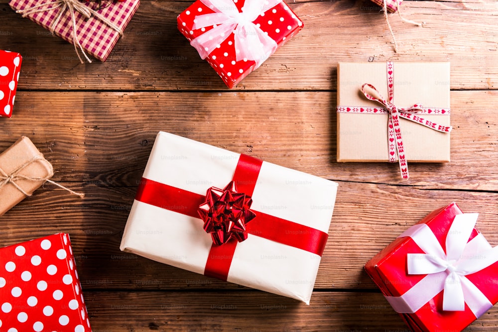Christmas presents laid on a wooden table background
