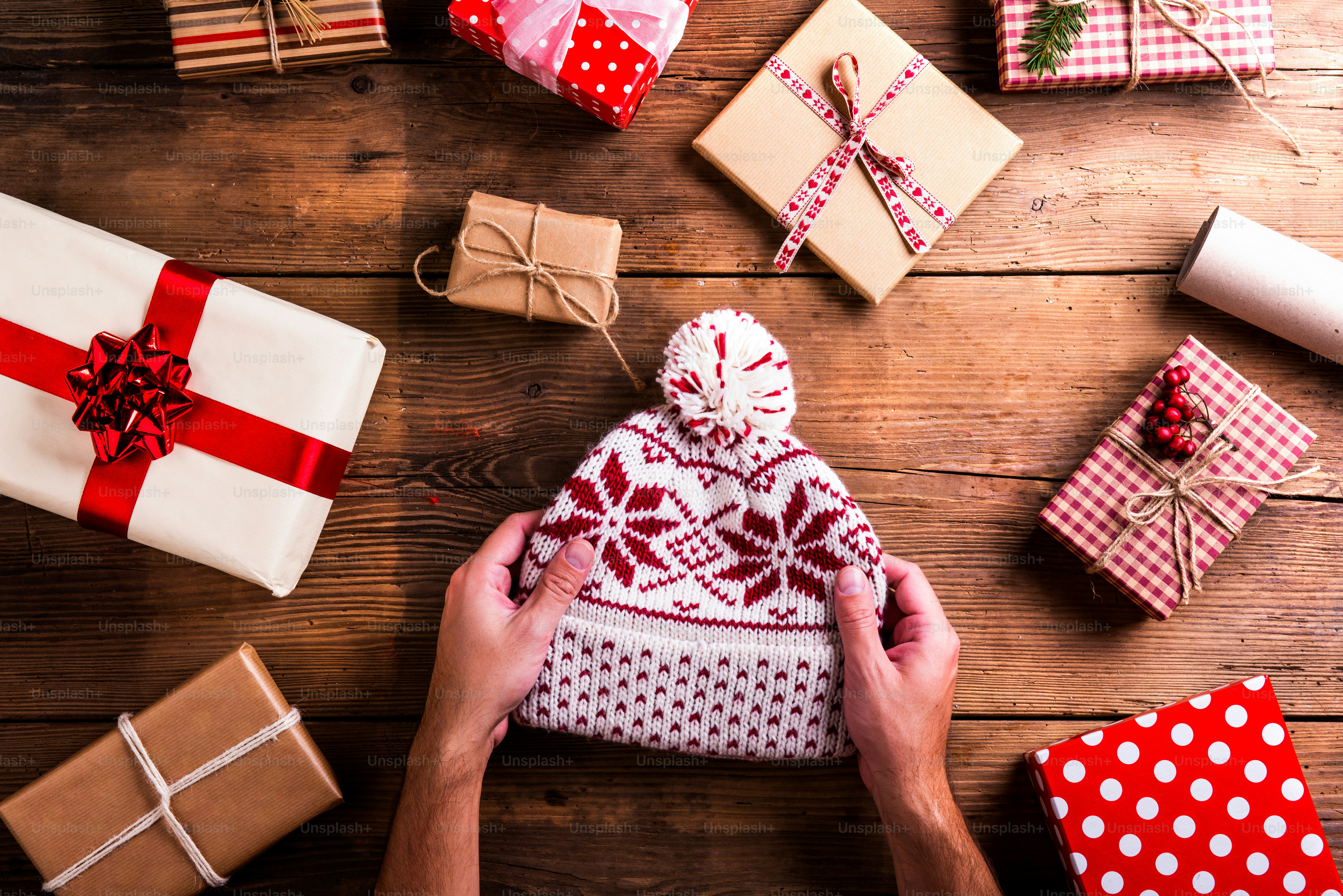 Christmas presents laid on a wooden table background