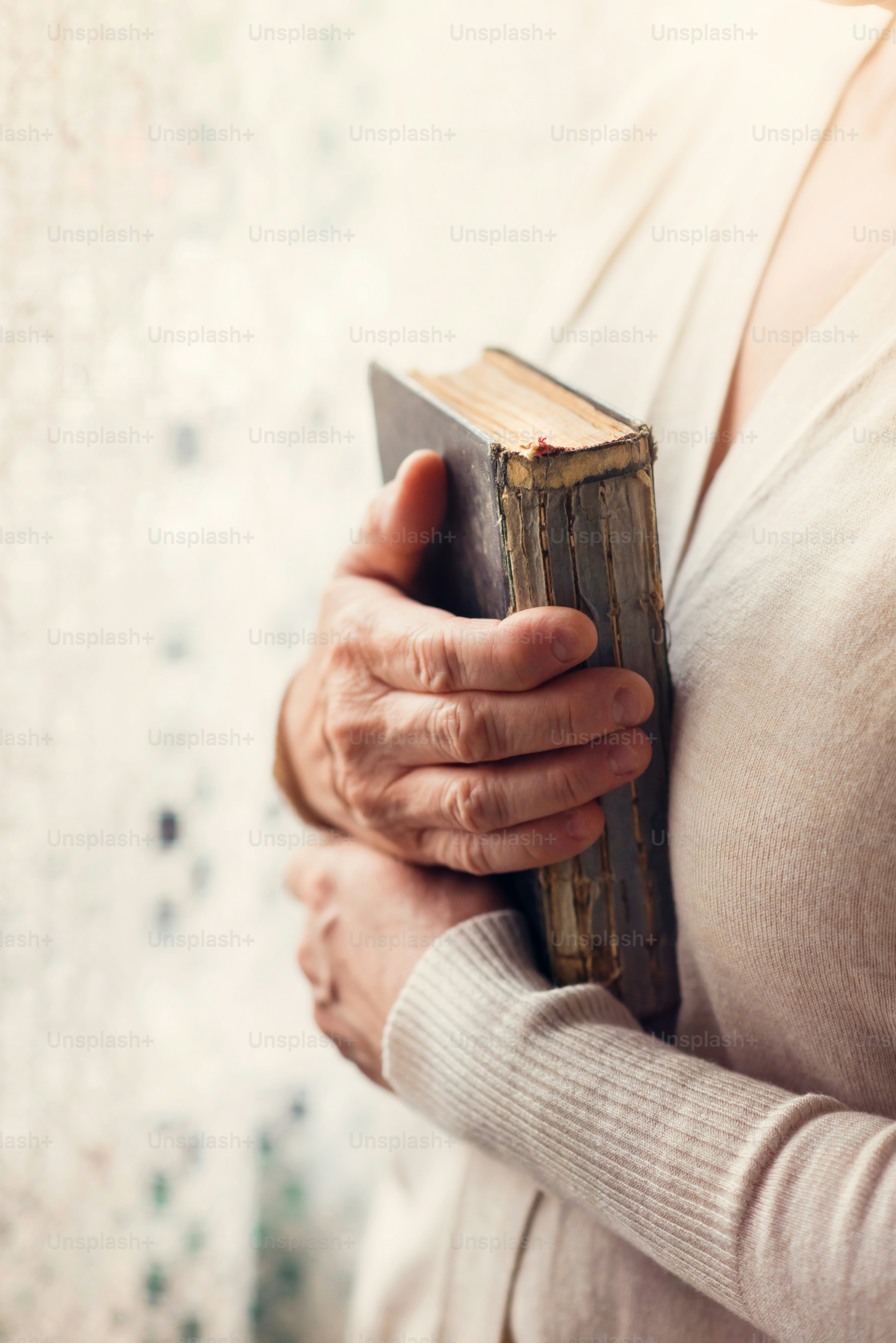 Unrecognizable woman holding a bible in her hands