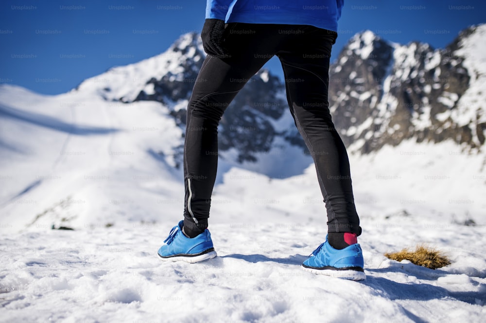 Legs of a young runner outside in winter nature