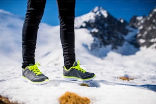 Legs of a young runner outside in winter nature