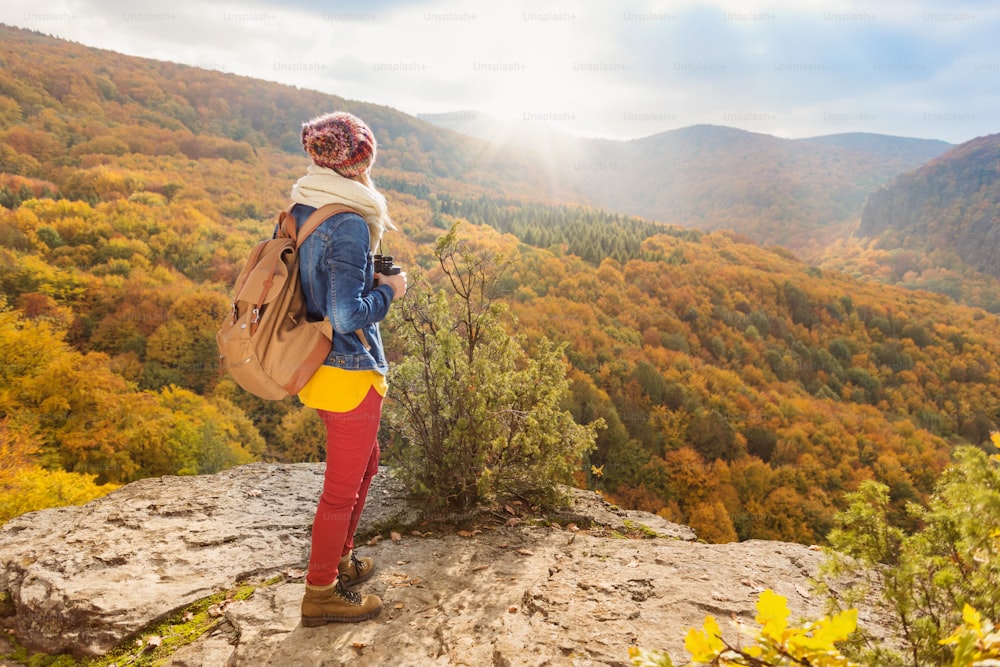 Beautiful young woman on a walk in autumn forest