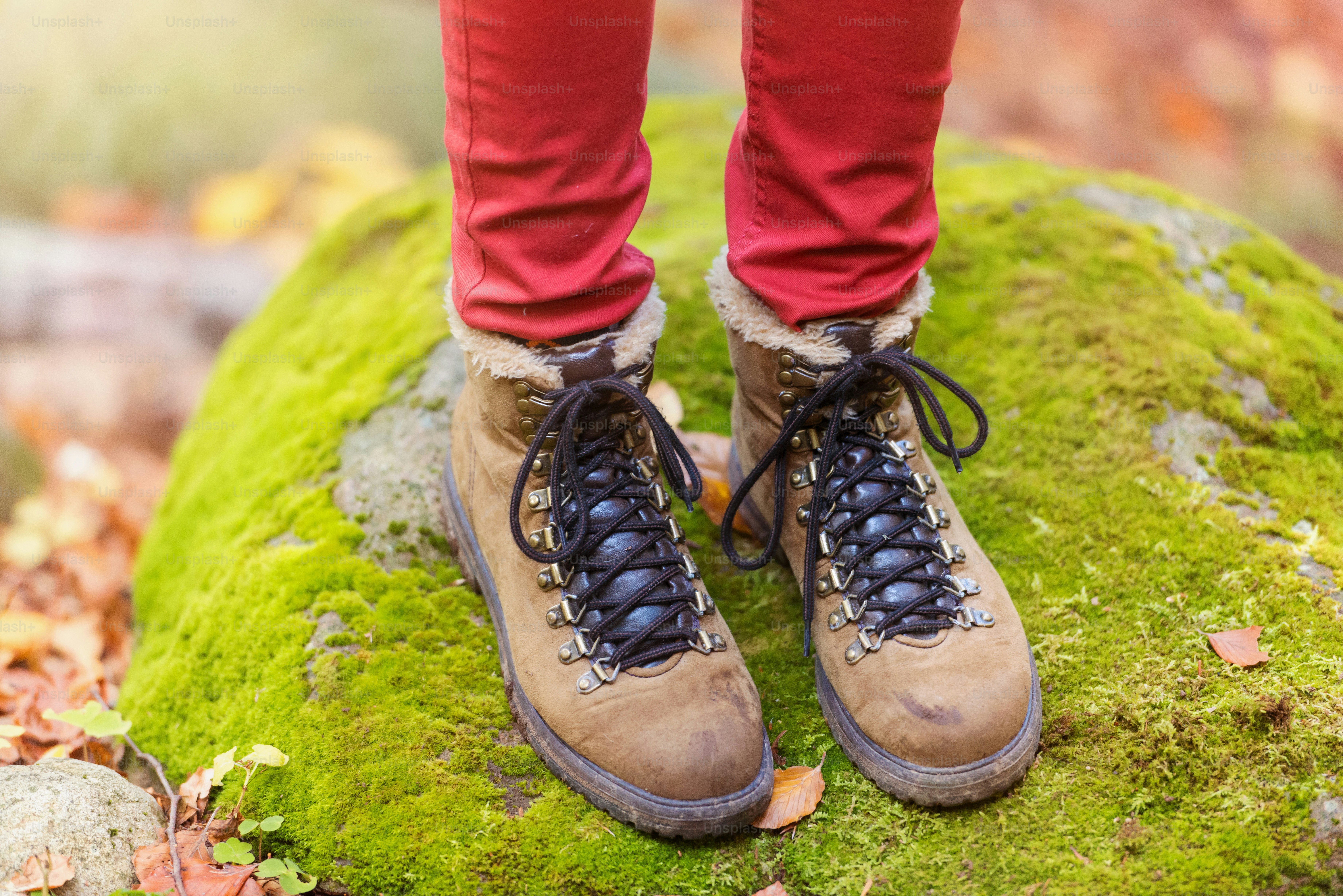 Legs of a woman on a walk in autumn forest