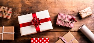 Christmas presents laid on a wooden table background