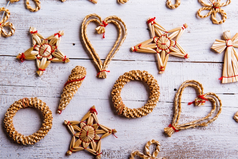 Christmas straw decoration. Studio shot on white wooden background.