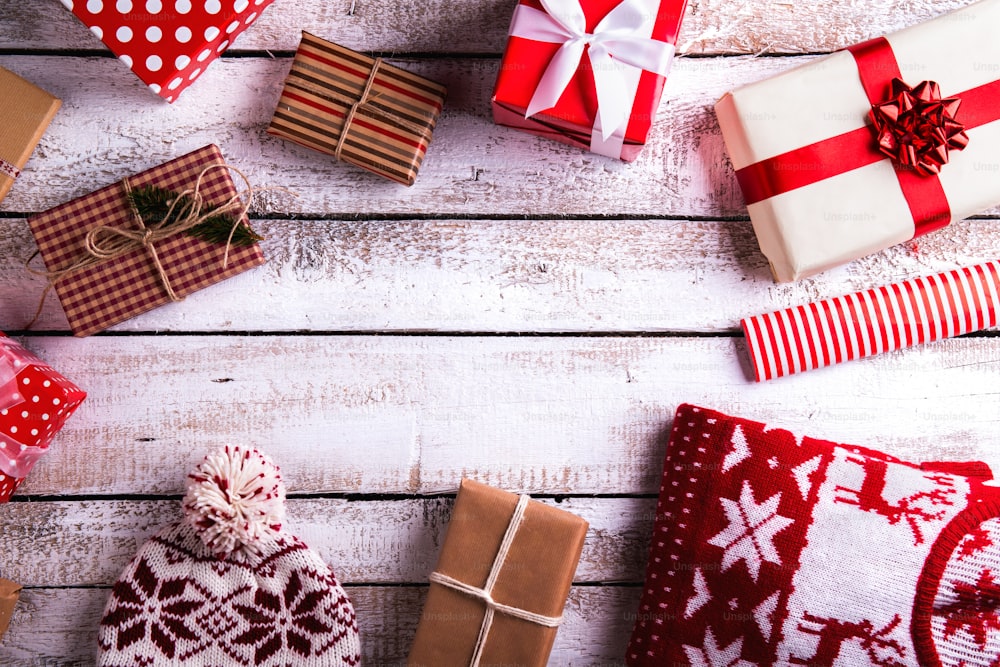 Christmas presents laid on a white wooden table background