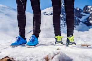 Legs of two runners outside in winter nature