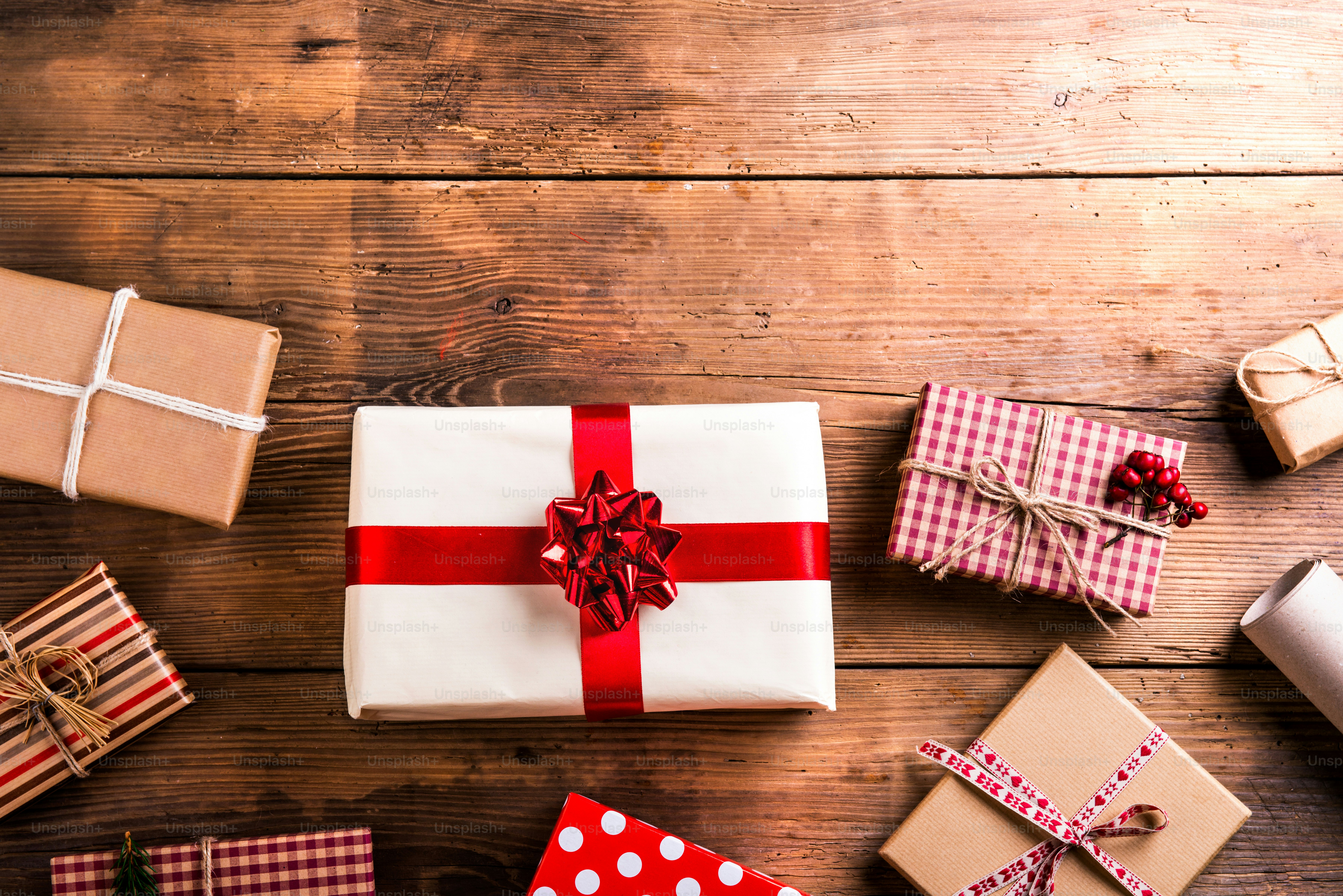Christmas presents laid on a wooden table background