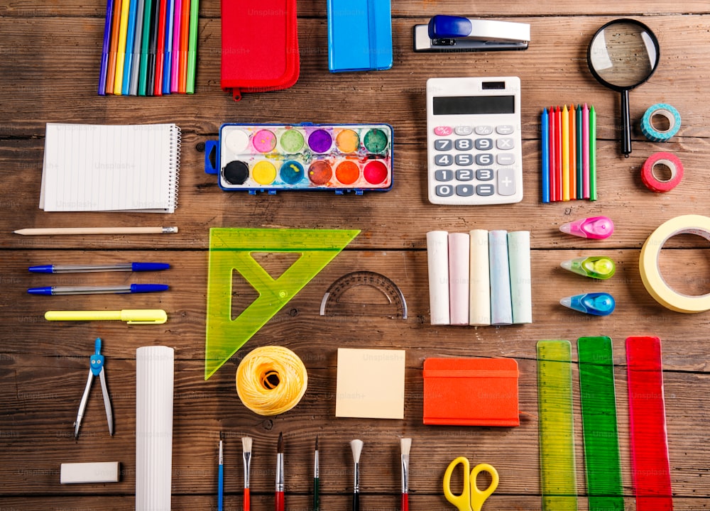 Desk with stationary. Studio shot on wooden background.