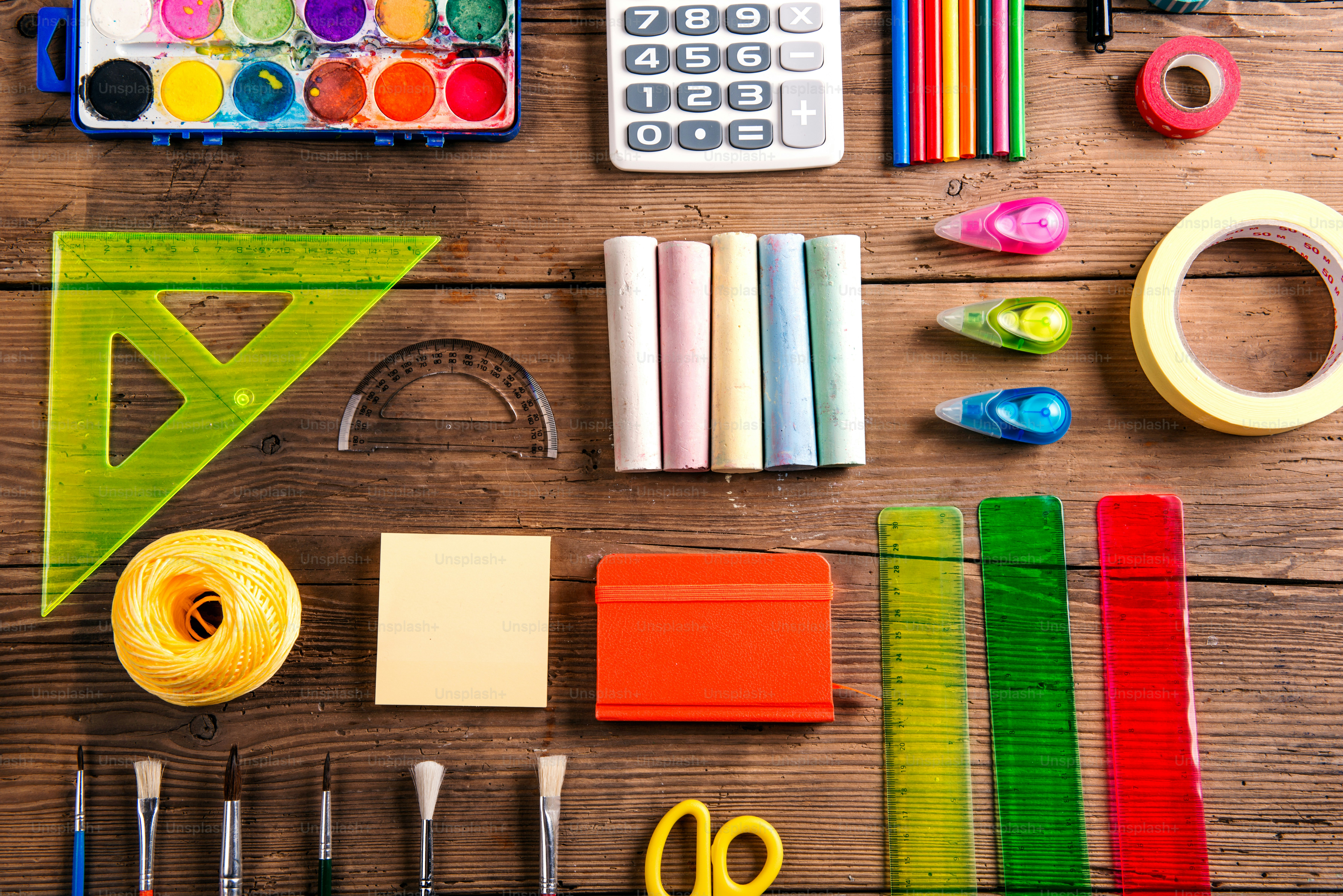 Desk with stationary. Studio shot on wooden background